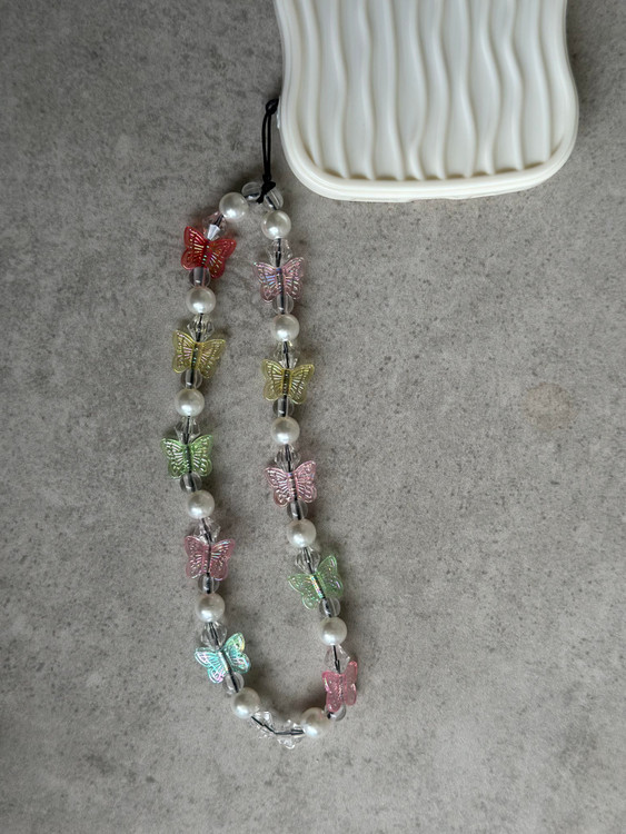 محافظ آیفون با بافت موجی سهبعدی و آویز فانتزی